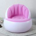 Child happily sitting on a bright yellow Kids Inflatable Sofa Chair with backrest.
