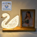 Duck-shaped crystal LED lamp glowing softly with photo frame
