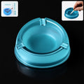 Transparent plastic ashtray with three cigarette rest slots and wide bowl