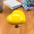 Close-up of a vibrant red heart-shaped knob, ideal for cabinets or drawers.