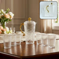 Textured glass water jug set with six matching glasses on dining table