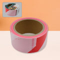 Bright red and white non-adhesive safety warning tape roll.