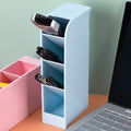 Clear plastic desktop pen holder with four compartments, neatly organising pens and pencils.