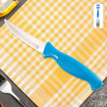 Stainless steel kitchen knife with ergonomic handle on wooden surface