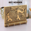 Elegant wooden elephant key holder mounted on a wall.