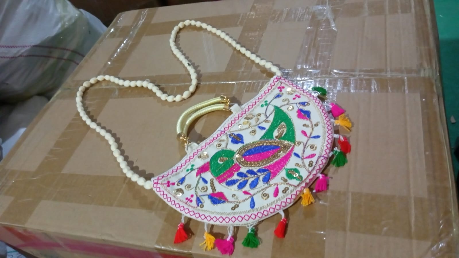 Lifestyle shot of the colorful Rajasthani handbag, perfect for everyday ethnic wear.