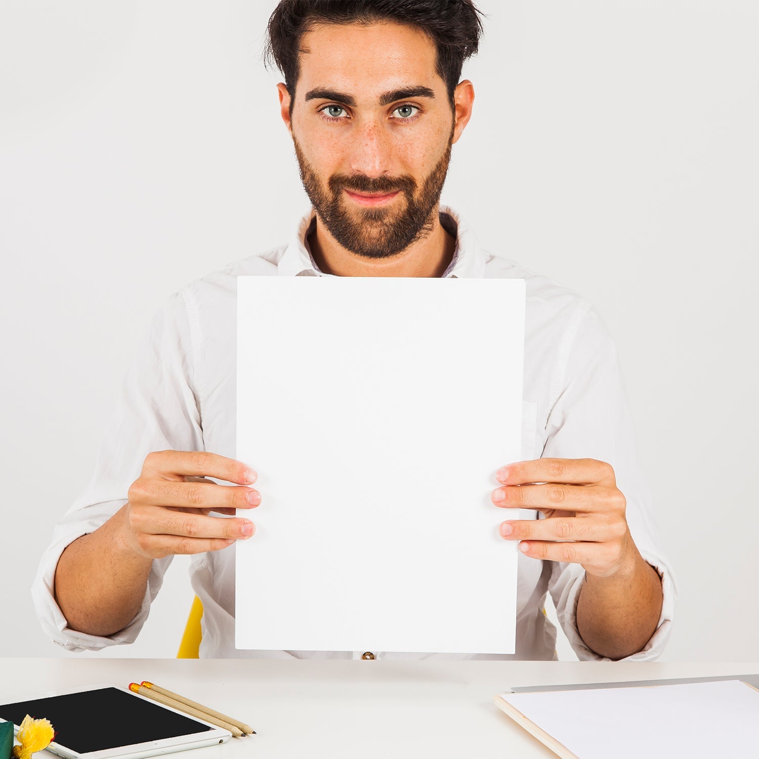 A4 copier paper stack on wooden desk with office supplies