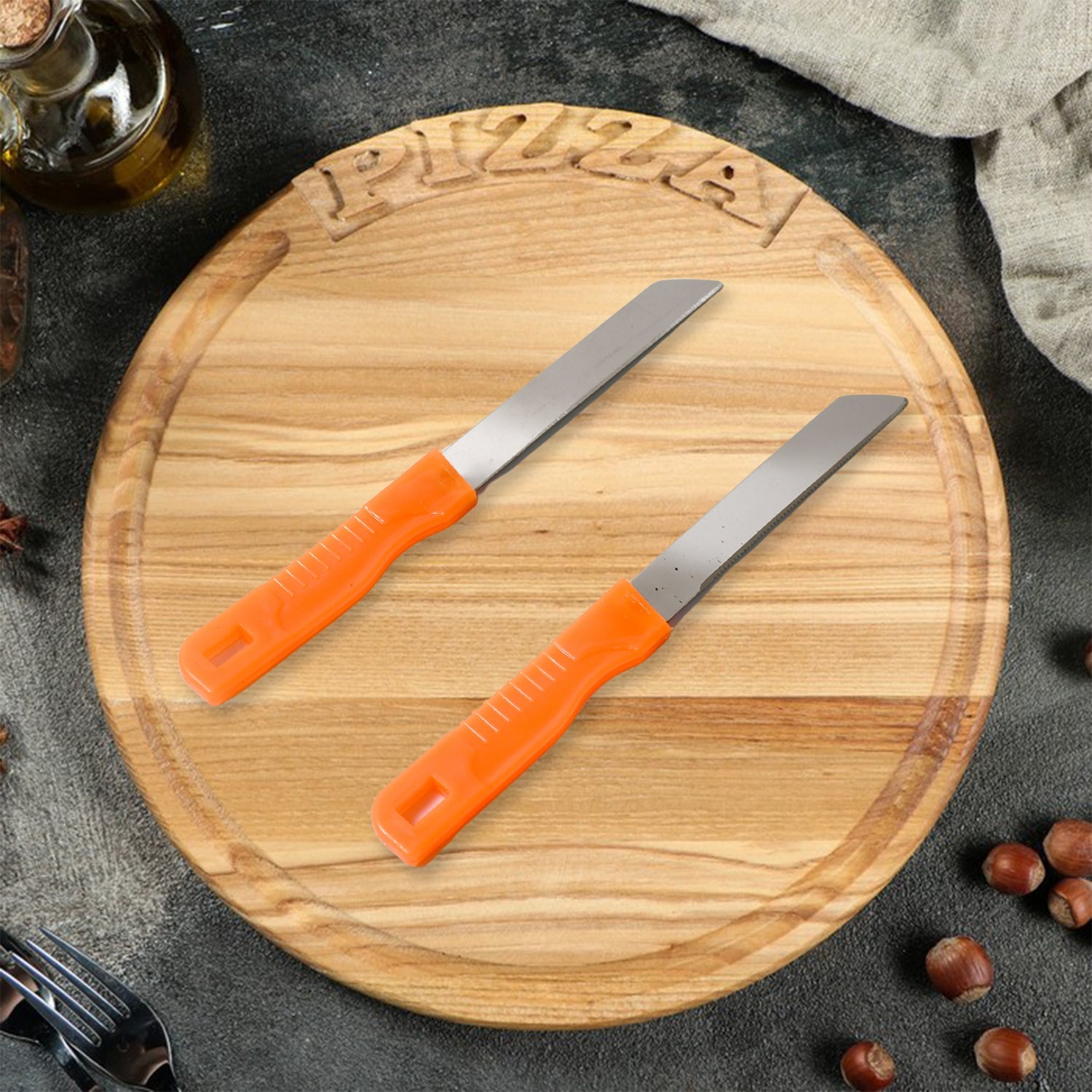 Stainless steel kitchen knife expertly slicing fresh vegetables on a cutting board.