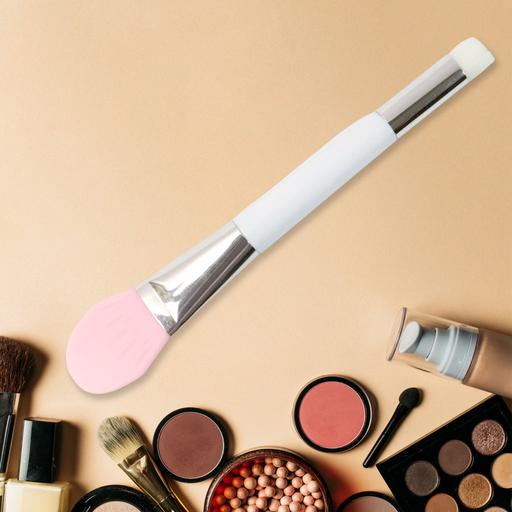 Hand holding silicone applicator brush for facial mask application