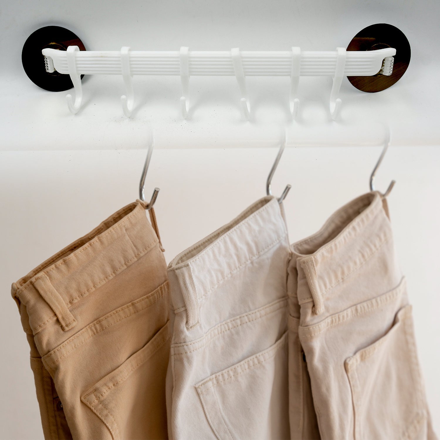 Side view of the sleek, wall-mounted towel holder rack in a minimalist design.