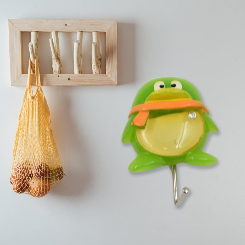 Cute green frog self-adhesive wall hook with strong backing, ready for installation.