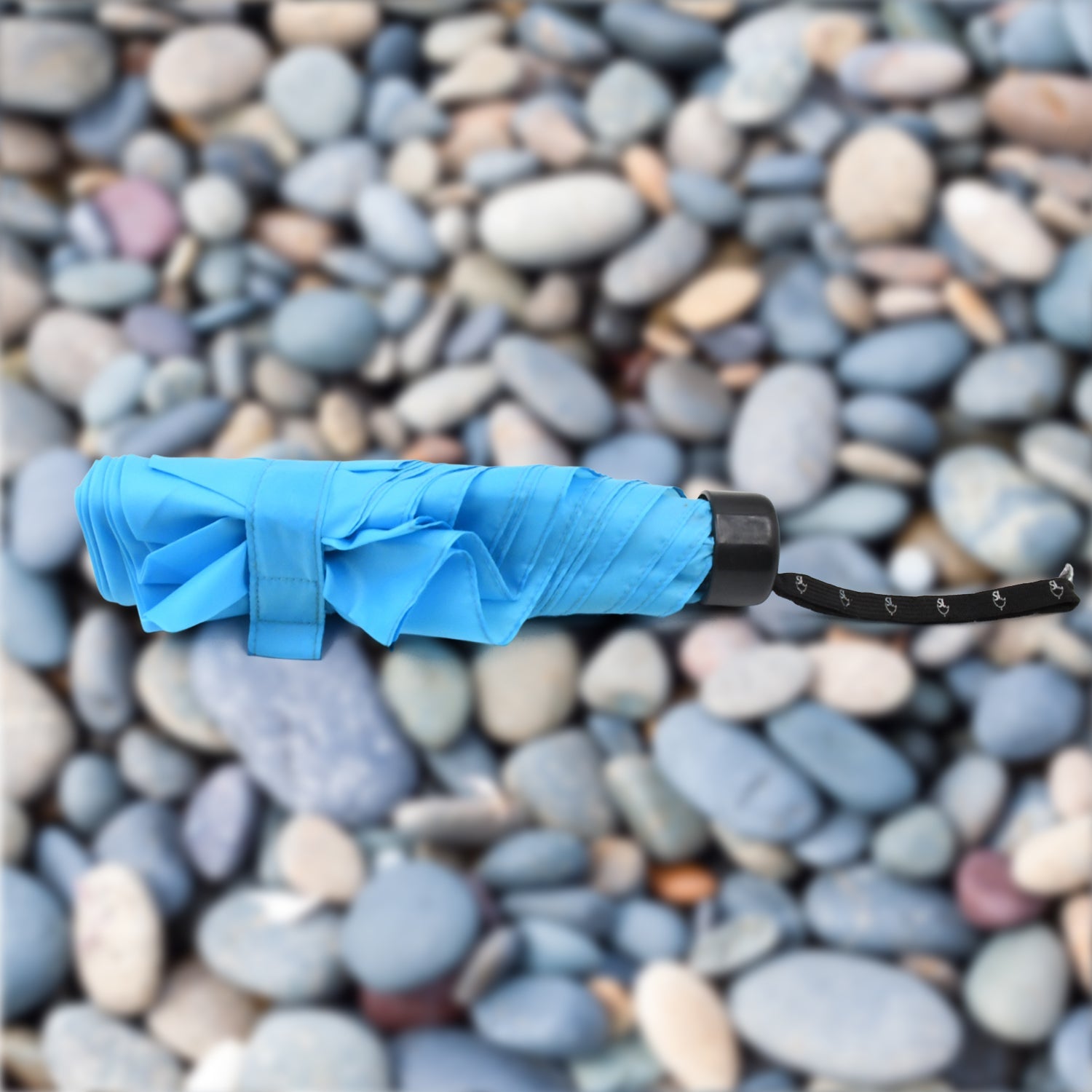 The DrizzlePro 3-fold umbrella neatly packed in its protective sleeve, ready for compact storage.