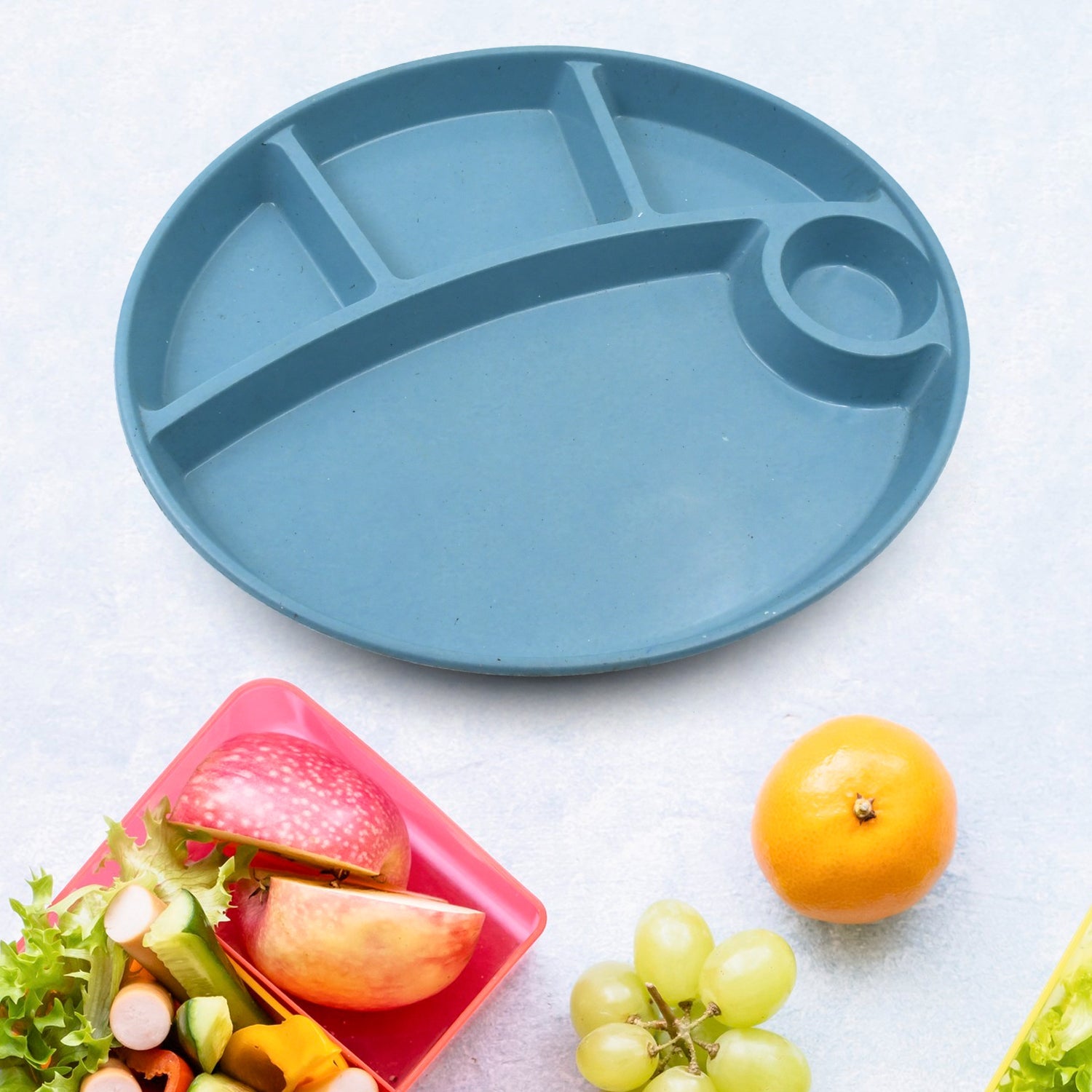 Jiaqi 5-compartment kids plate with spoon on a rustic wooden table.