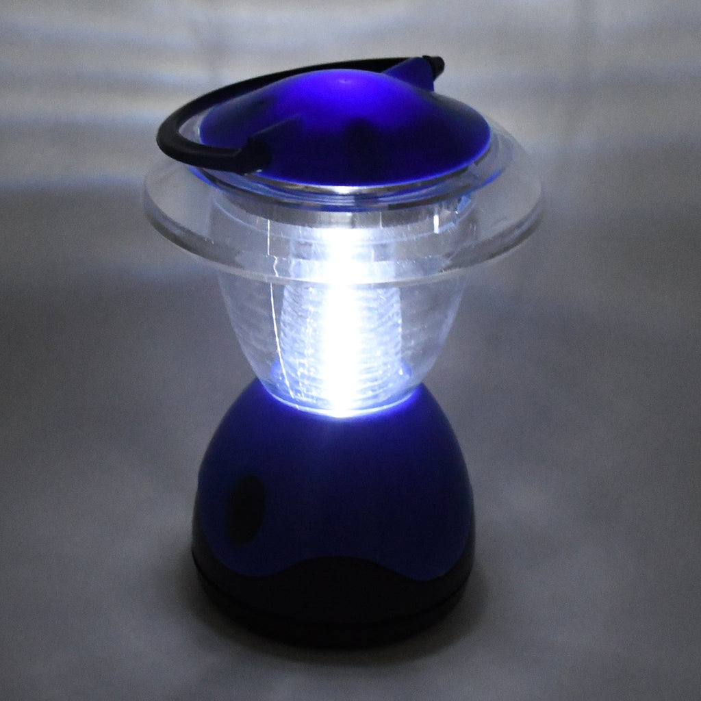 Person holding the compact Indo Glow Mini Camping Lantern, showcasing its portable design.