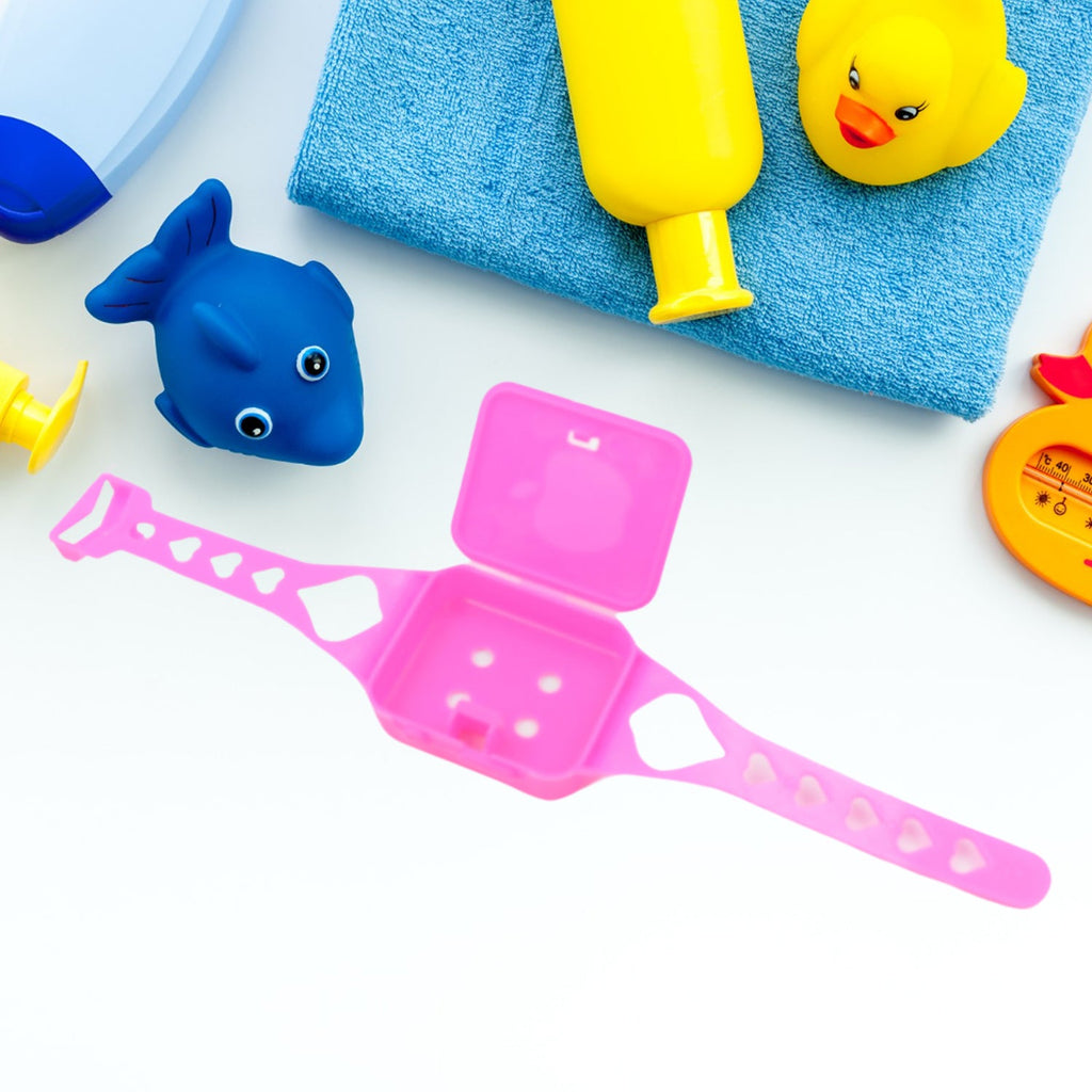 Overhead view of the Barbie-themed play set components arranged neatly, highlighting the toy phone, watch, and glasses.