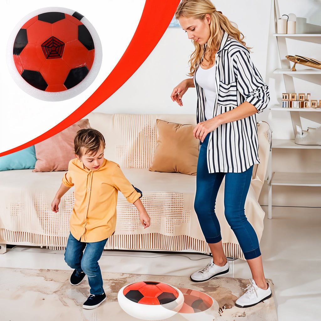 Child playing with soft kick hover soccer ball indoors