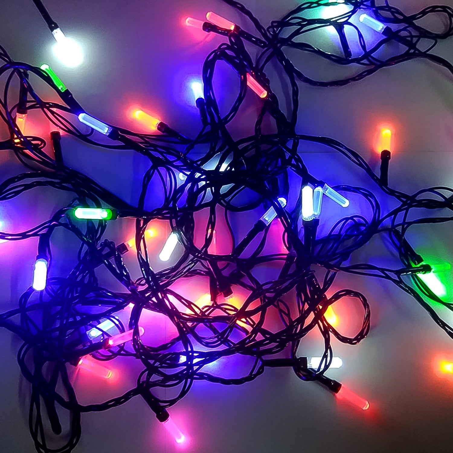 Multi-color Diwali LED string light illuminating a festive home setting.