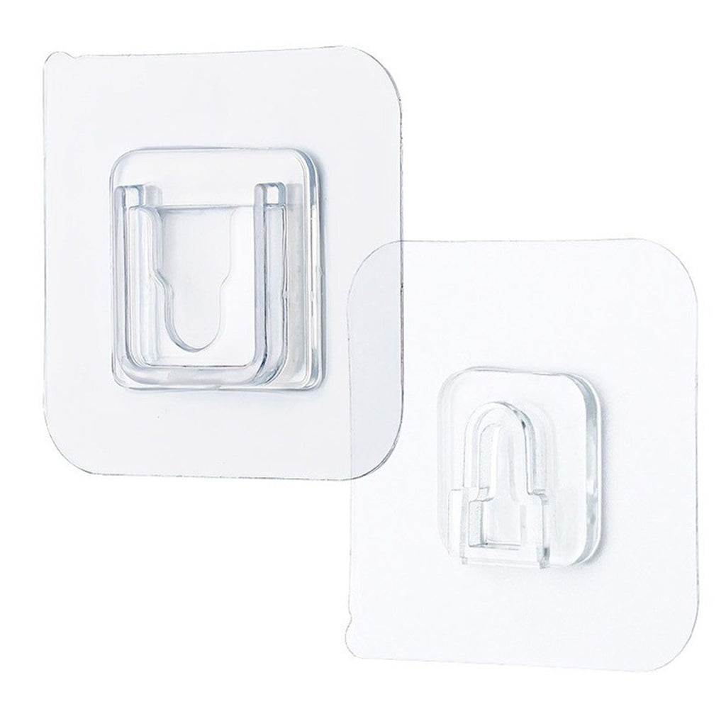 Single clear adhesive hook securely mounted on a smooth wall surface.