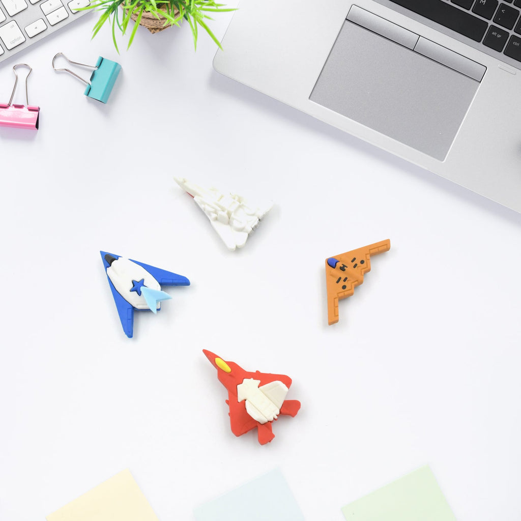 Assorted gun and plane erasers displayed on a white background.