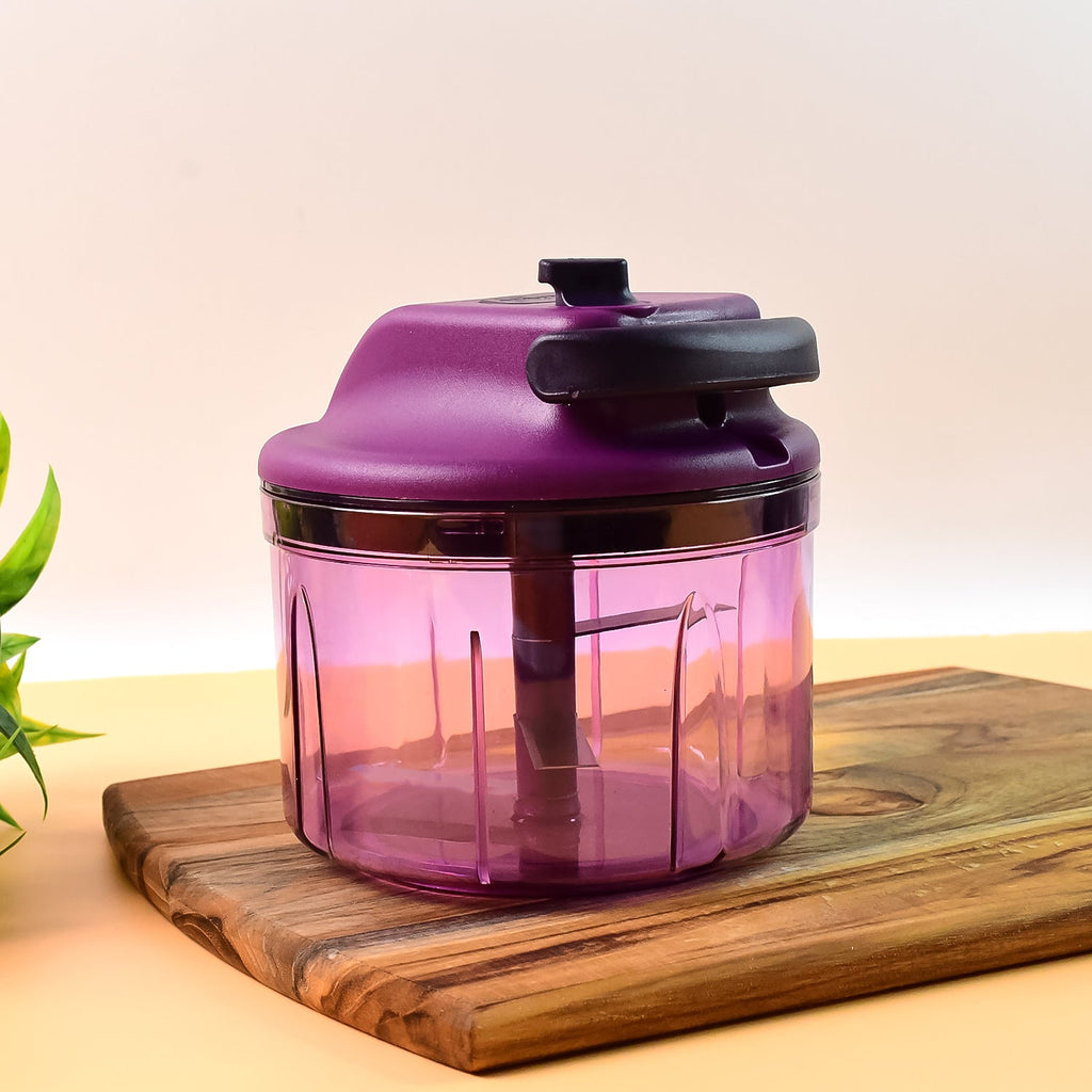 Compact manual vegetable chopper showing hand-pull operation