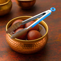Stainless steel chef serving tong with silicone grip on kitchen counter