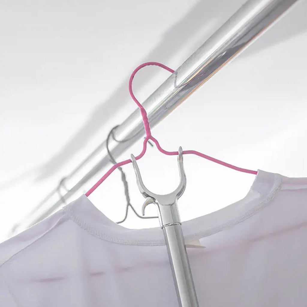 Collapsible garment hanging stick demonstrating its compact storage feature.