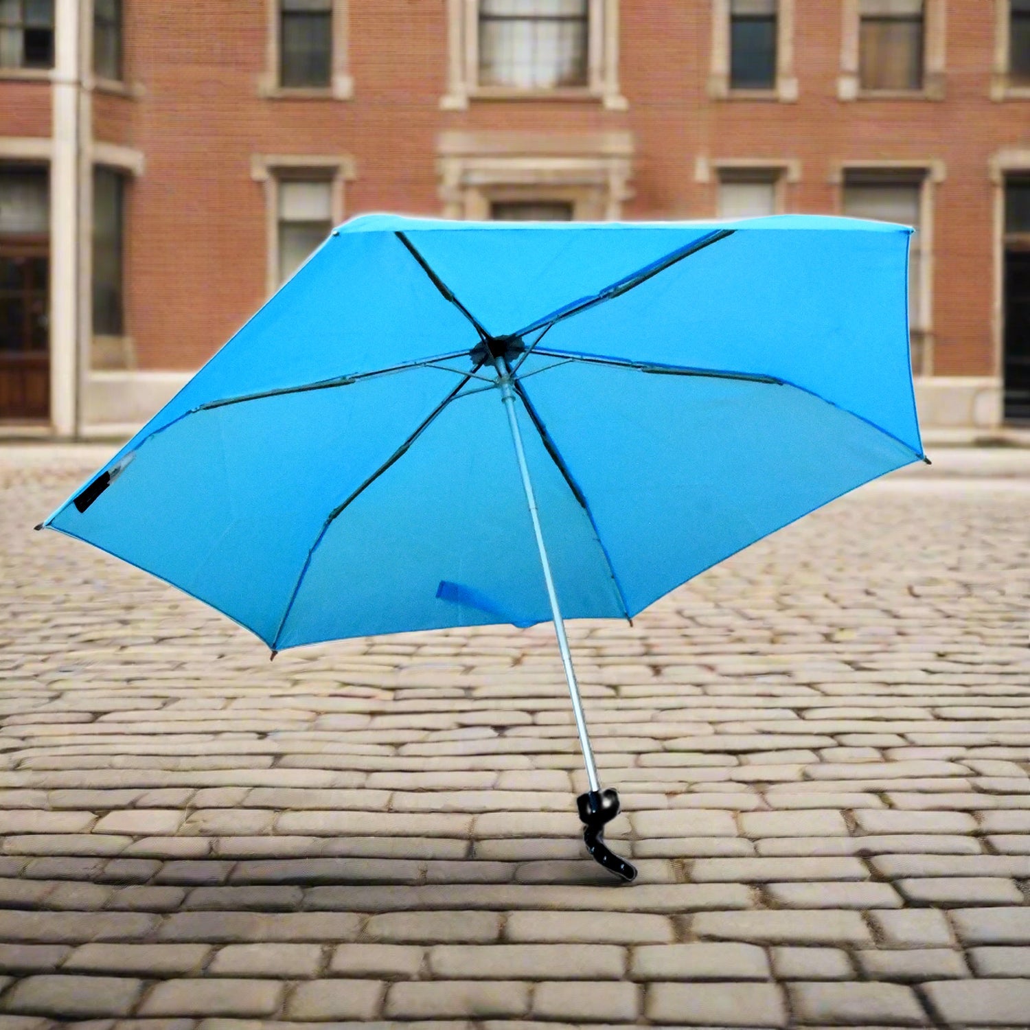 A DrizzlePro 3-fold umbrella featuring a playful cartoon design, perfect as a cute umbrella for children.
