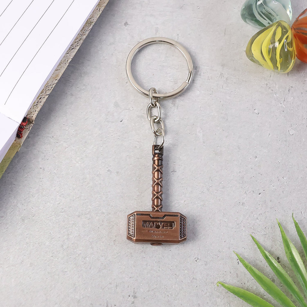 Side perspective of metal hammer keychain showing thickness