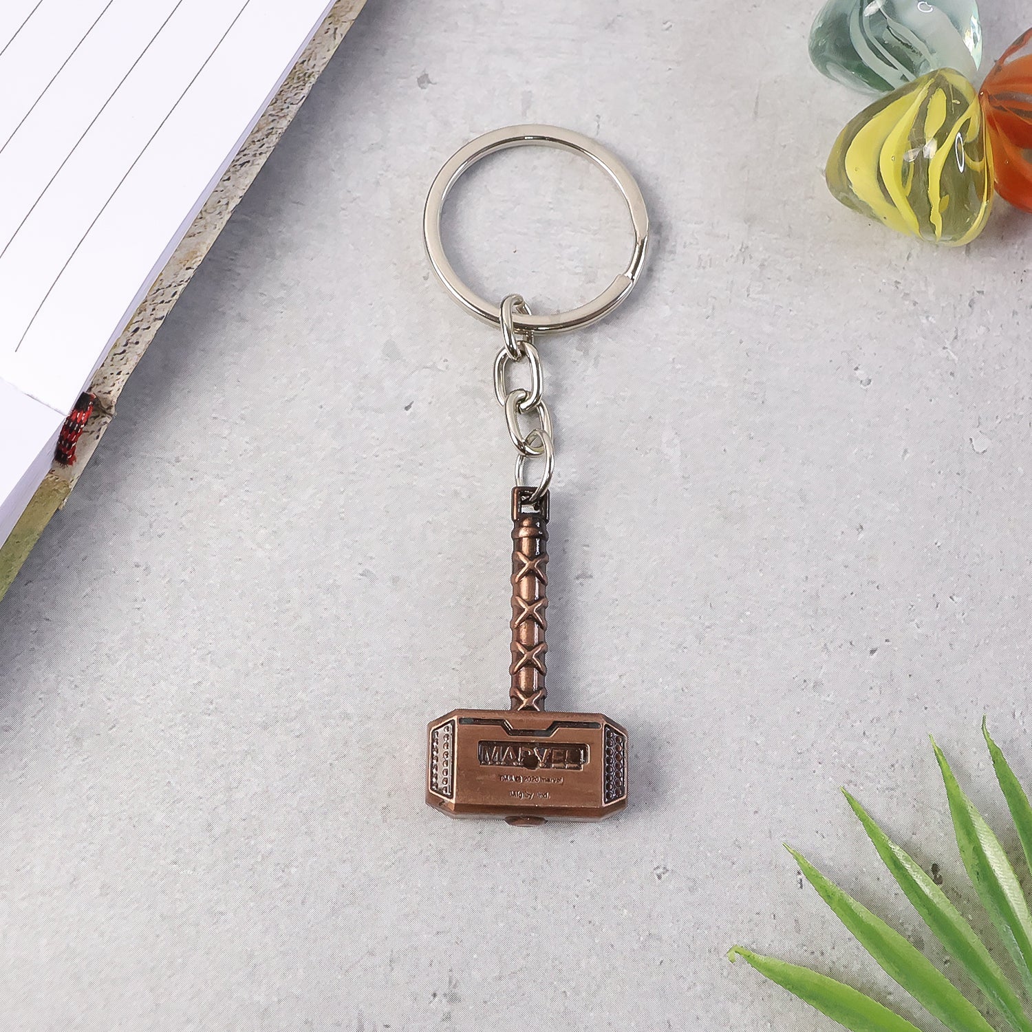 Side perspective of metal hammer keychain showing thickness