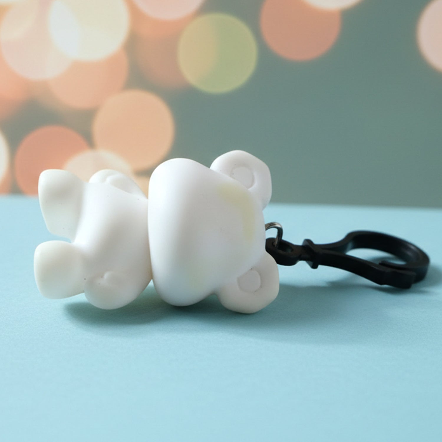 Bear figure keychain with smooth finish clipped on backpack side