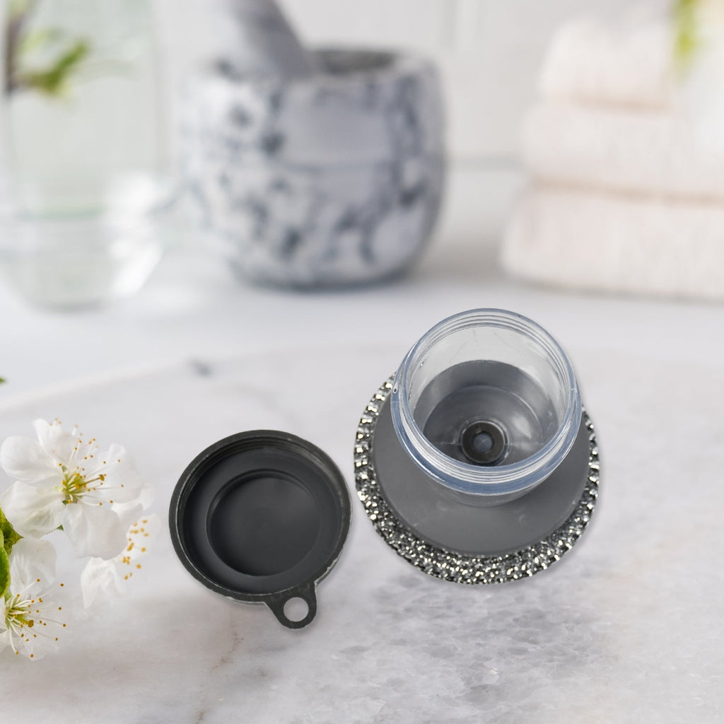 Compact kitchen cleaning brush with an integrated soap dispenser, ideal for small spaces.