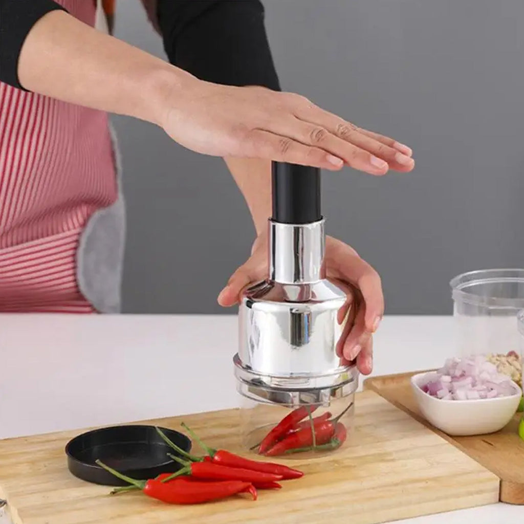 The CookAura vegetable chopper efficiently cutting garlic and fresh herbs.