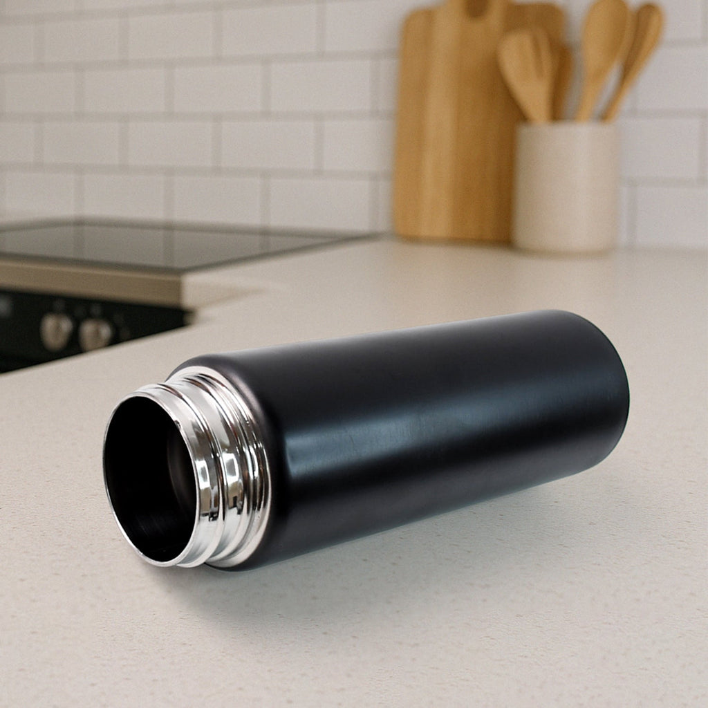 Side view of ergonomic stainless steel sports water bottle with flip-top lid