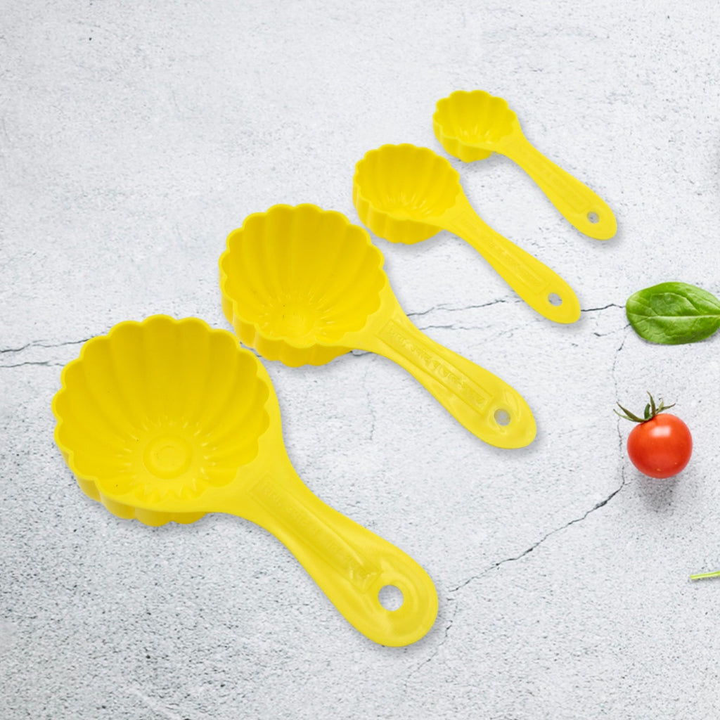 The complete set of four plastic ladoo making spoons, ideal for crafting various traditional sweets.