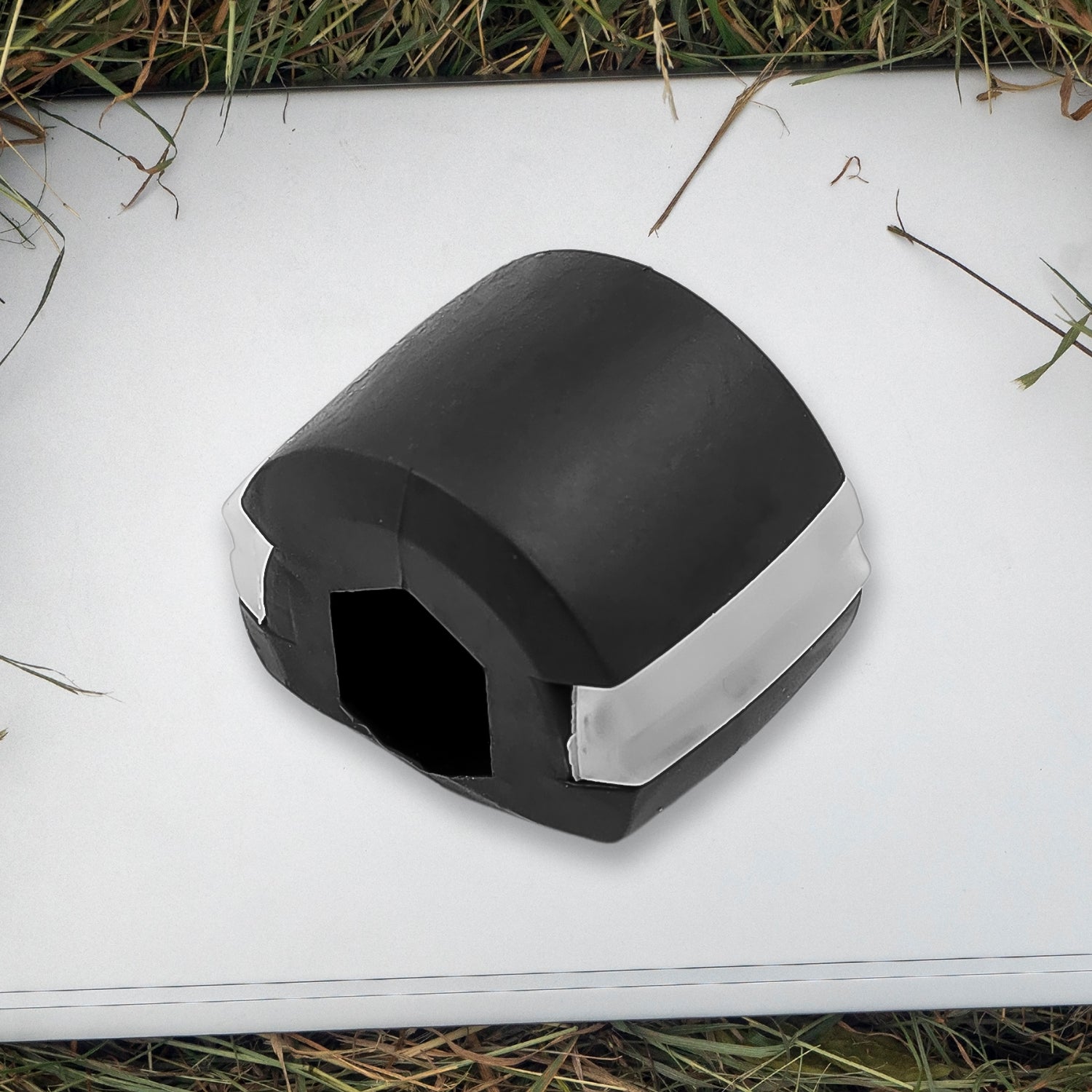 Side profile of the black Jaw Exerciser, showing its compact size.