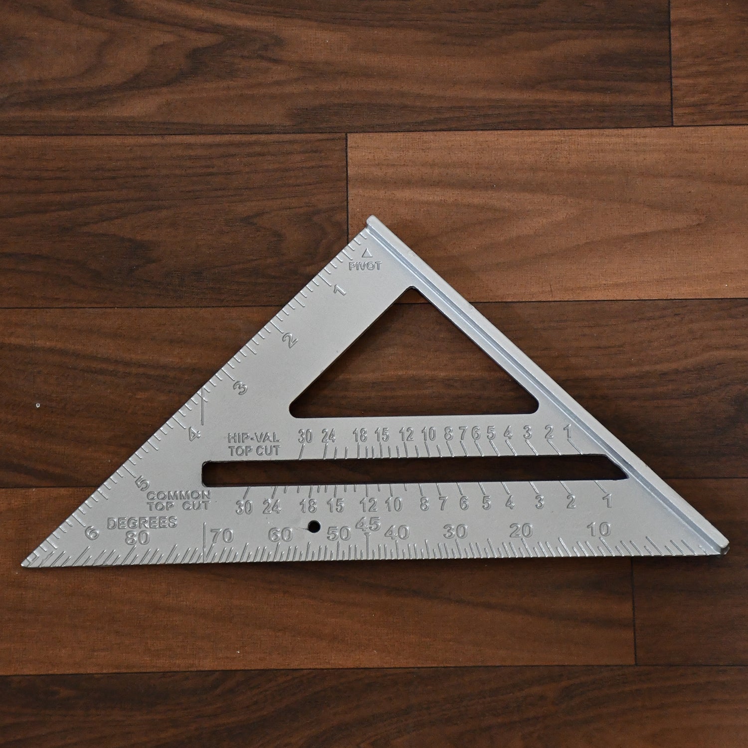 The lightweight BoltForce triangle ruler displayed next to other essential woodworking tools.
