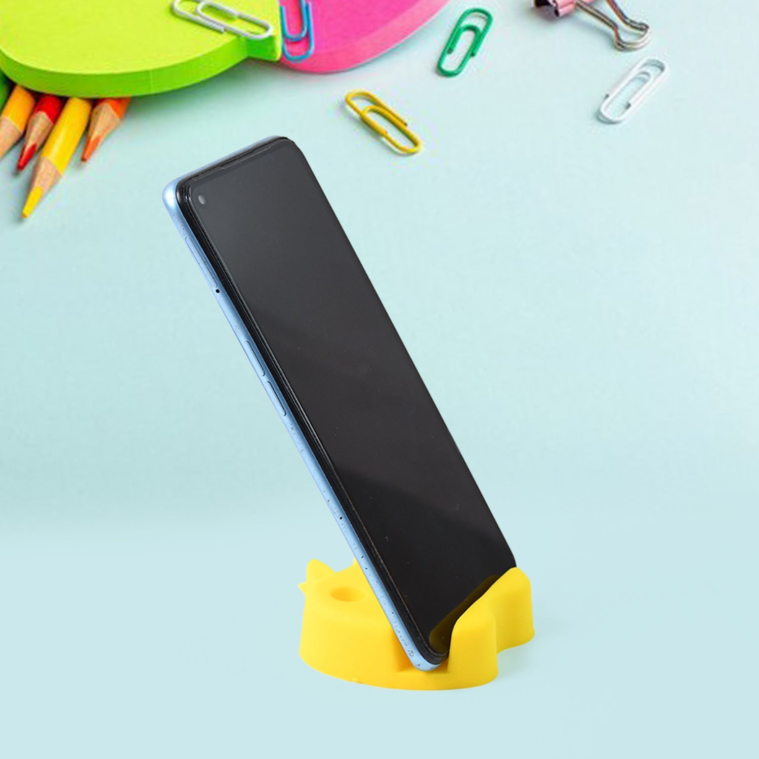 Close-up of apple-shaped mobile stand showing pen holder slots and phone support