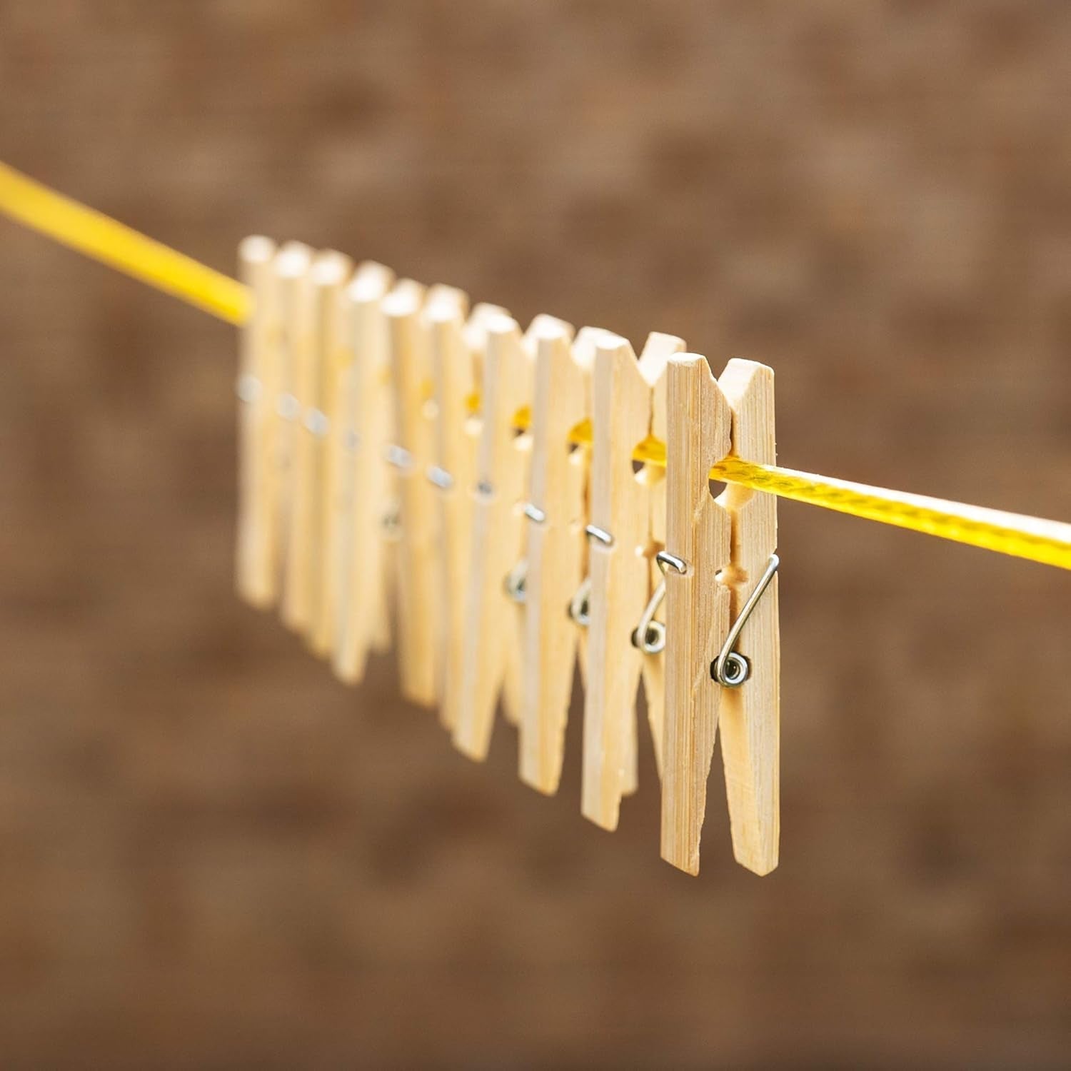 Sturdy bamboo wooden cloth clips with stainless steel springs, ready for household use.