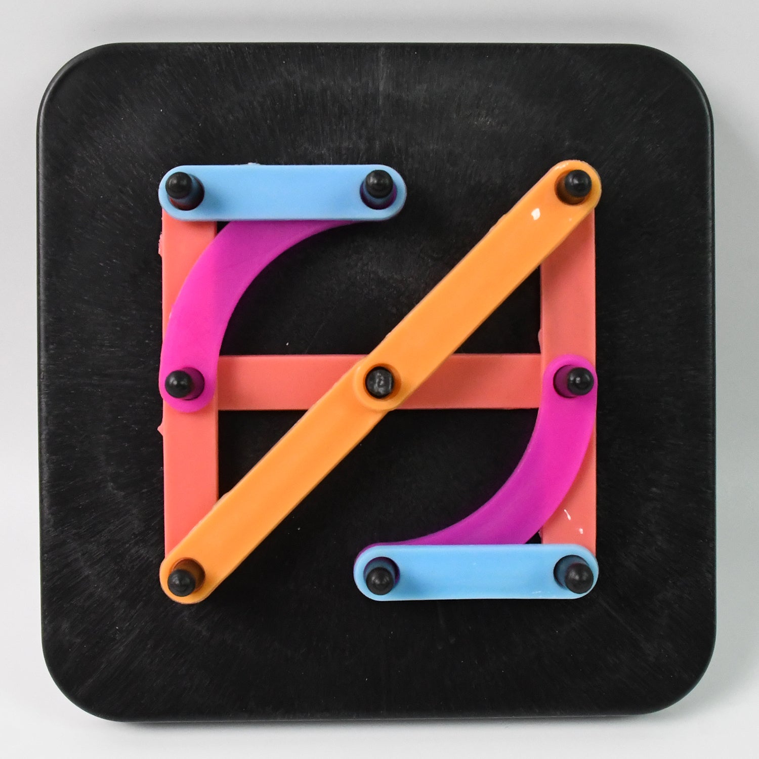 Brightly coloured alphabet numeric puzzle pieces arranged in a grid pattern.