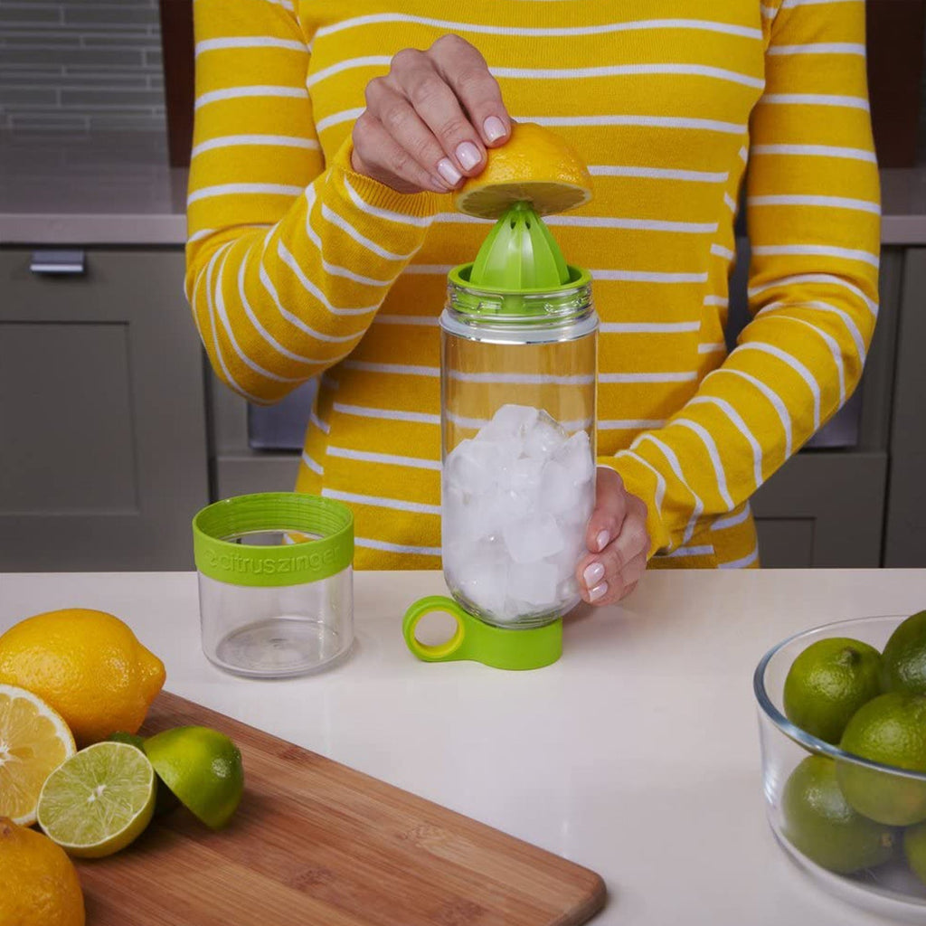 Demonstration of the juice maker bottle's removable bottom cap for easy citrus juicing and cleaning.
