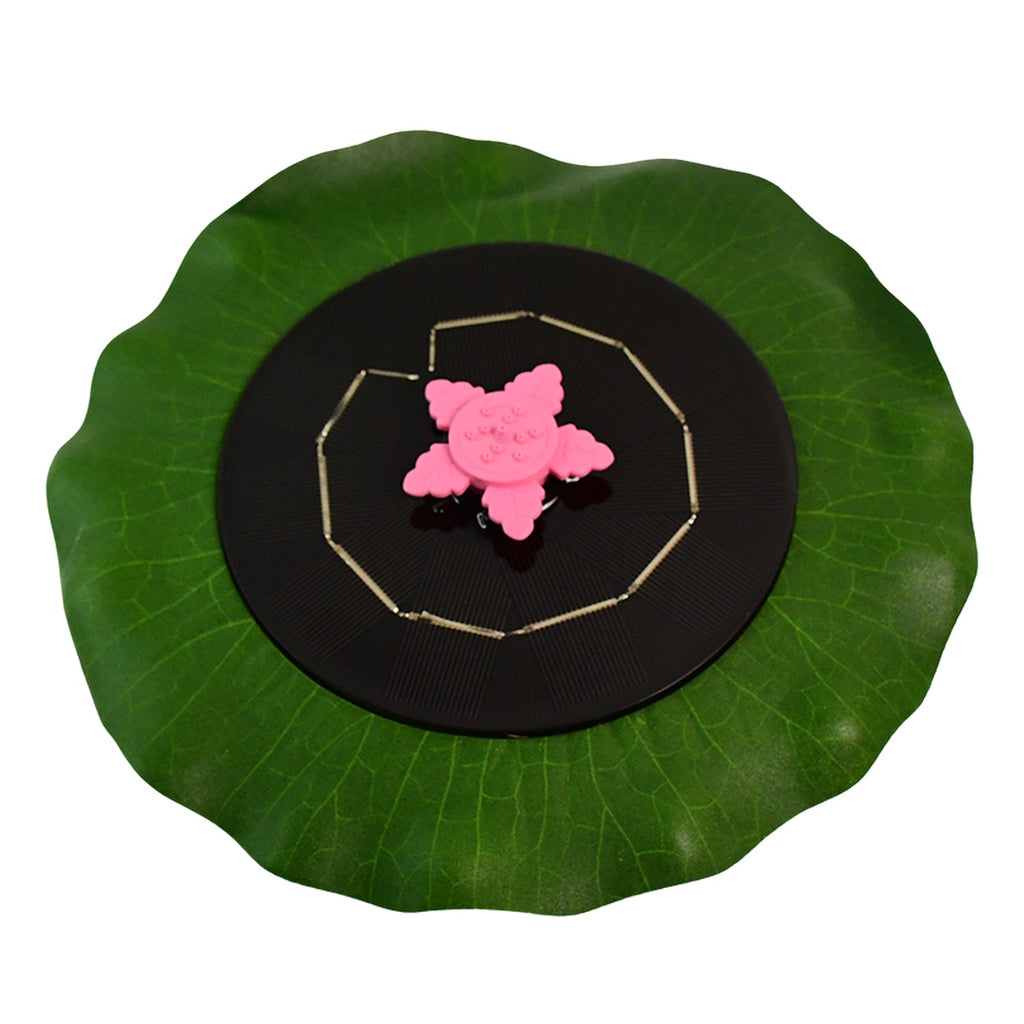 Solar garden fountain pump floating on water with green base and solar panel