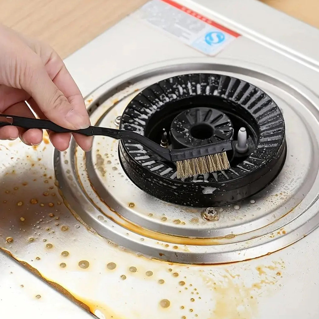Hand holding a brass wire brush demonstrating its comfortable grip for cleaning.