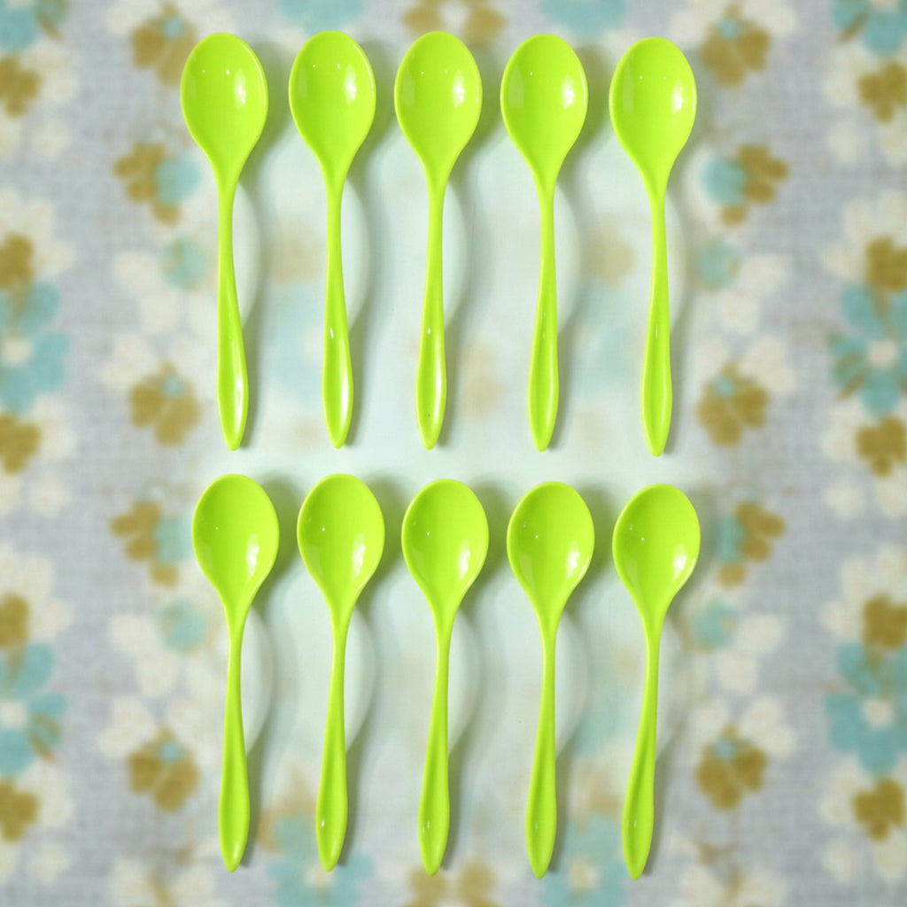 A single reusable plastic spoon placed elegantly on a table setting.
