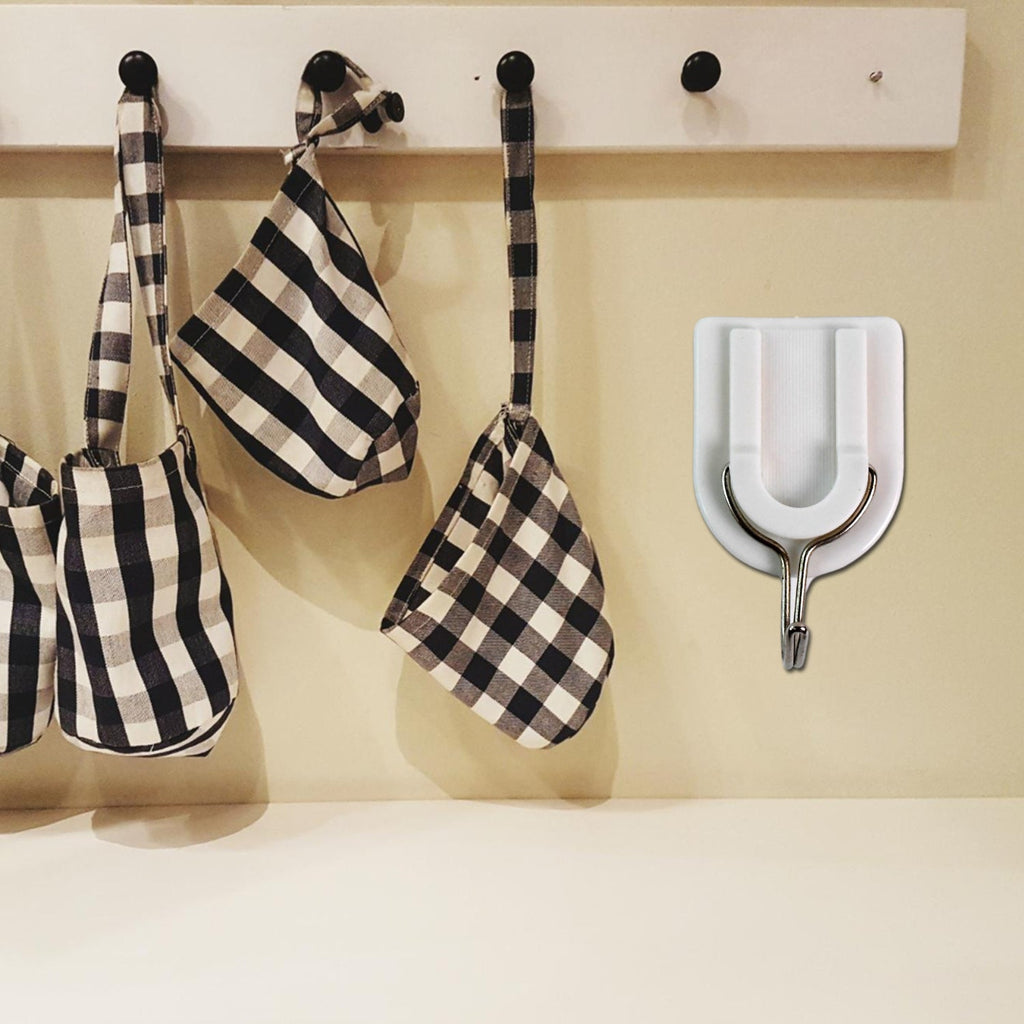 Practical adhesive wall hook holding a small purse, demonstrating its versatile use.