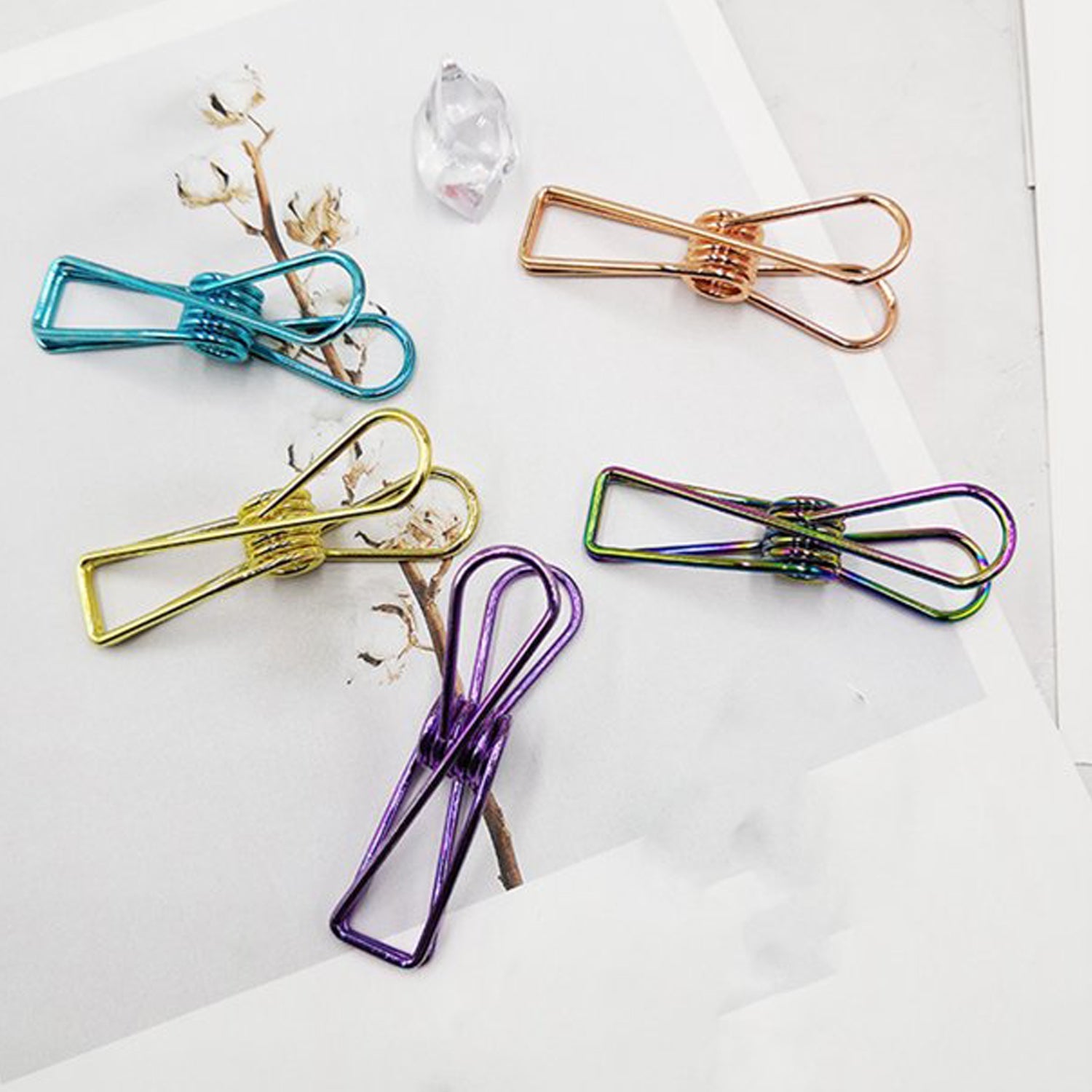 Several multipurpose stainless steel laundry clips scattered, suggesting everyday utility.