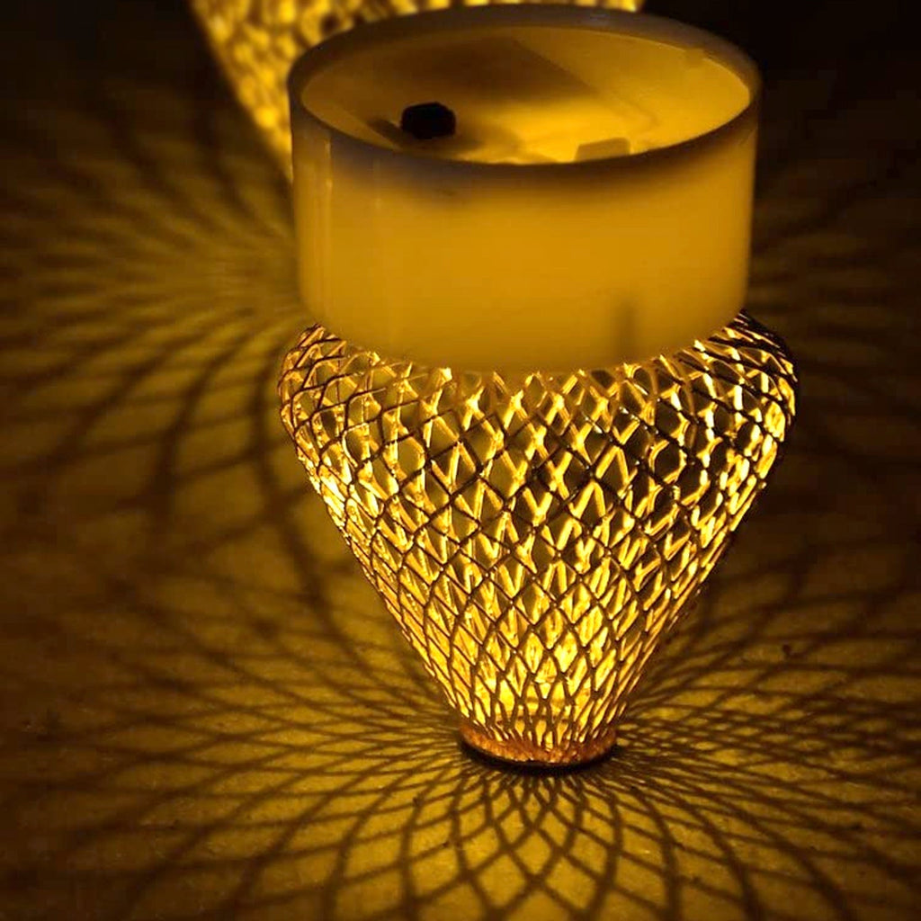 Bottom view of a flameless LED candle showing the battery compartment and on/off switch.