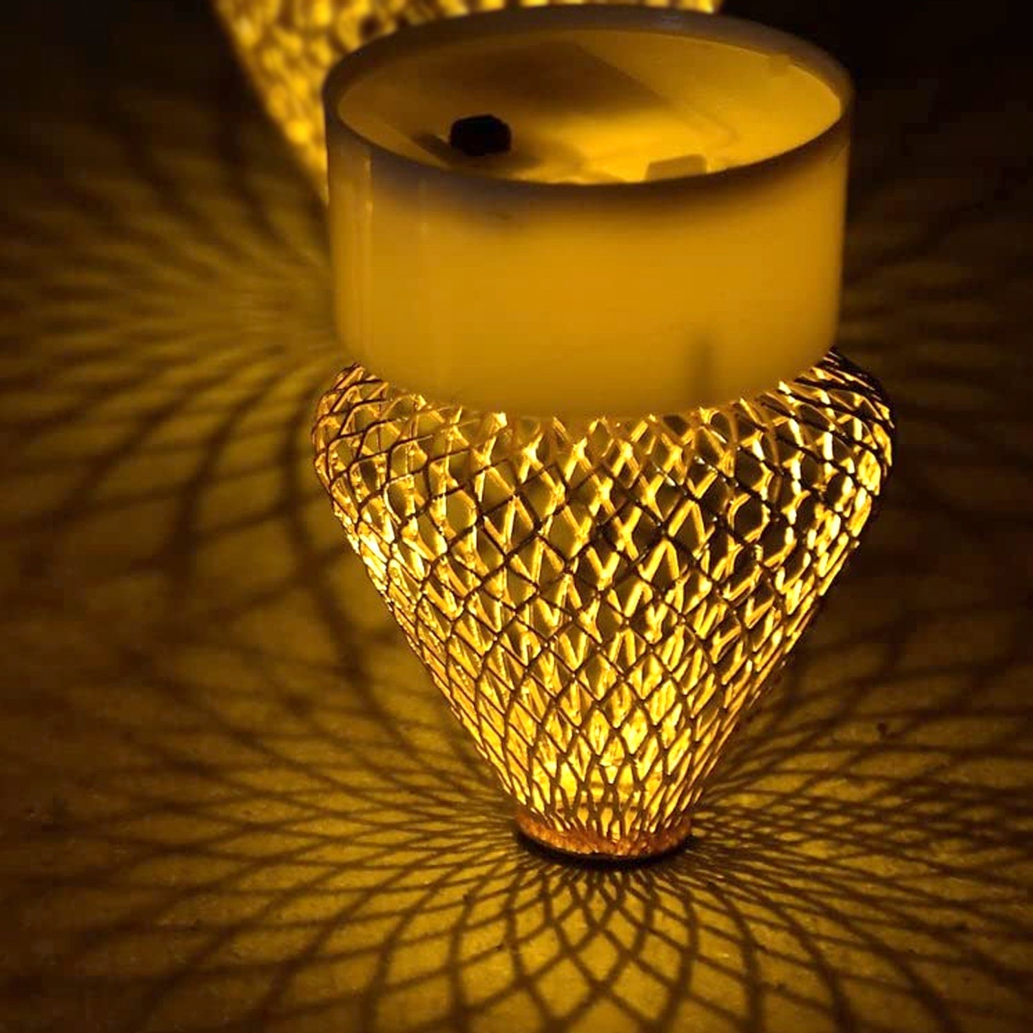 Bottom view of a flameless LED candle showing the battery compartment and on/off switch.