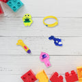 Colorful Kids Toy Combo with a soldier, rattle, and other toys, presented in a traditional Potli bag.