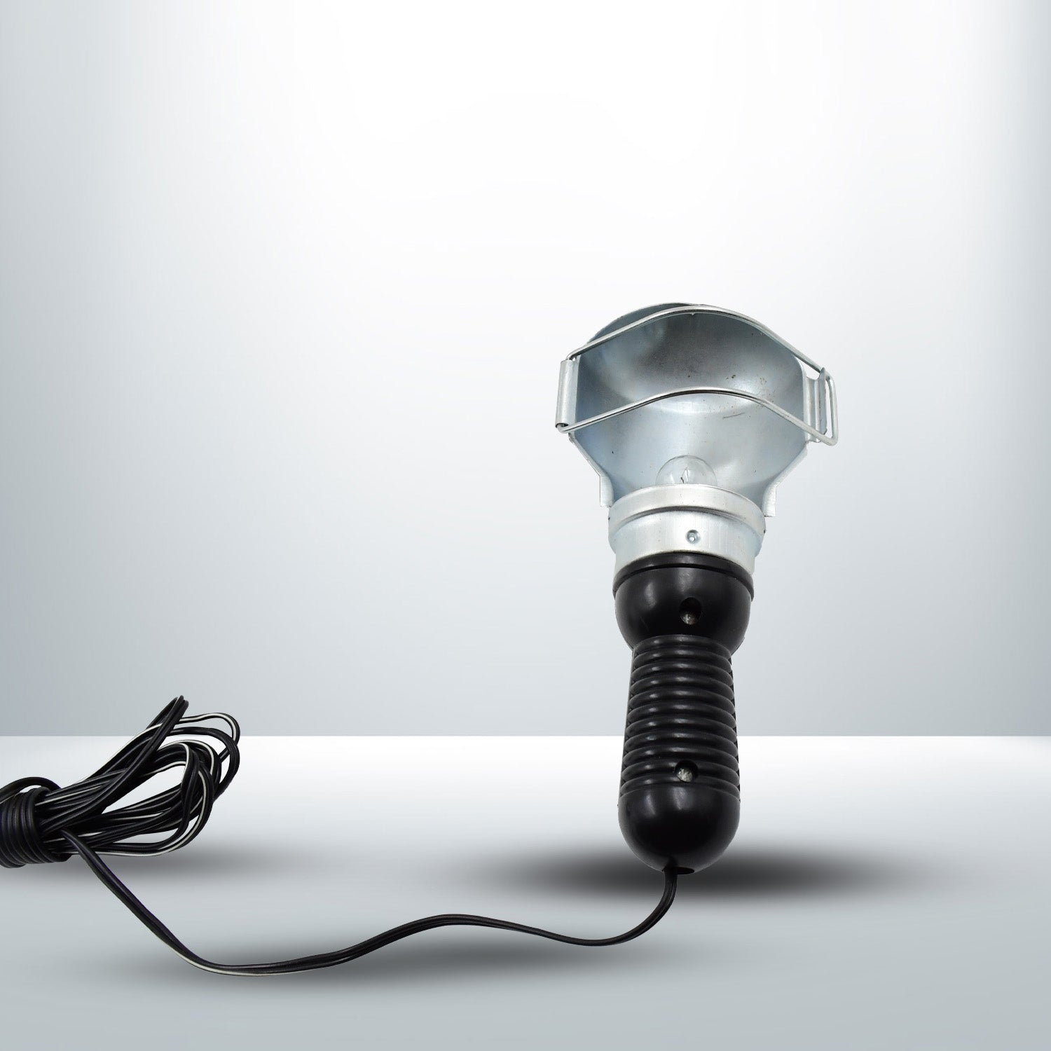 The Portable Work Lamp placed on a surface, highlighting its stable base.