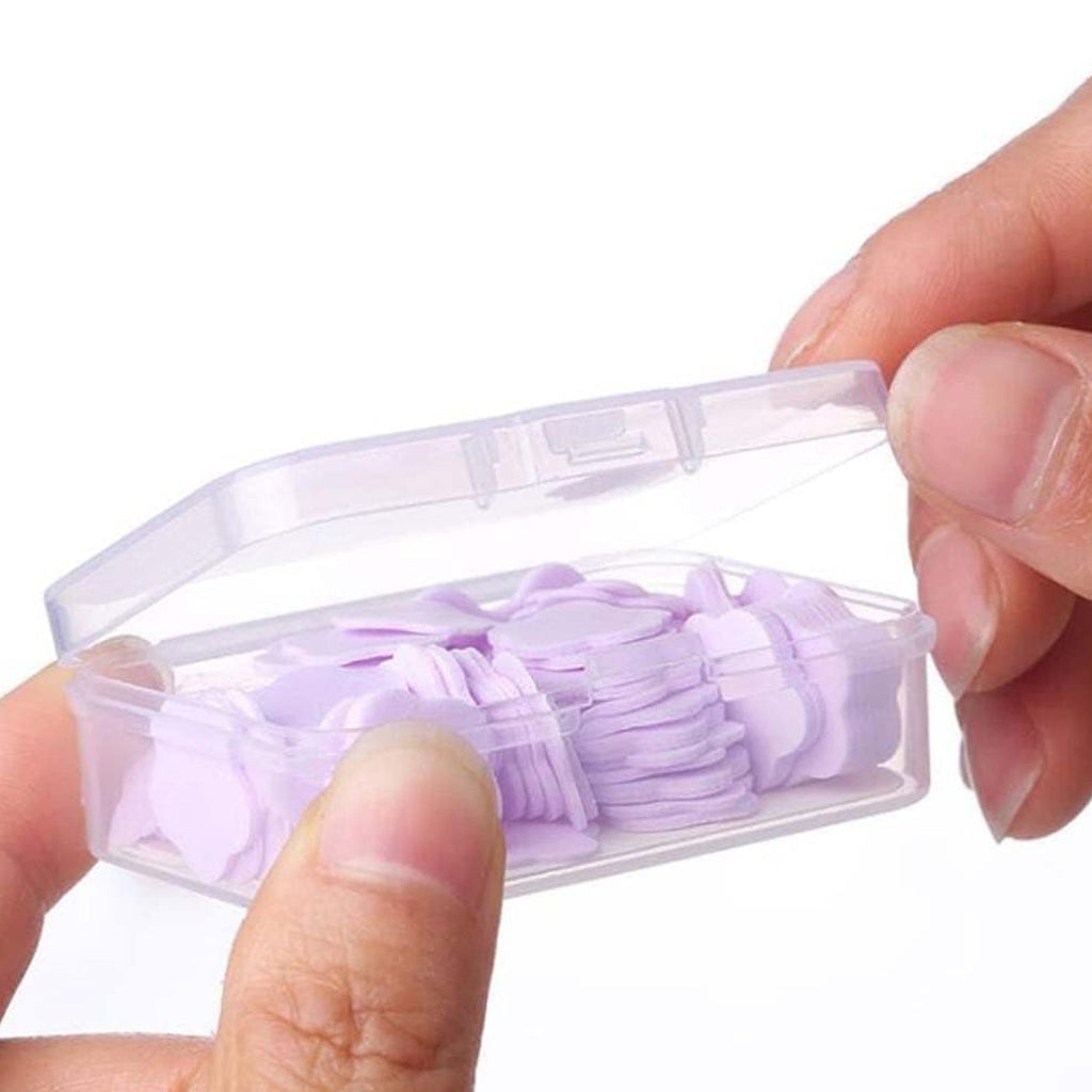 Hands lathering with a flower-shaped portable soap sheet, creating rich foam.